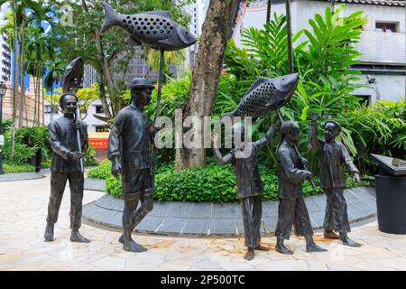 Sculpture représentant les activités du festival des premiers immigrants chinois à Singapour, Telok Ayer Green, Singapour Banque D'Images