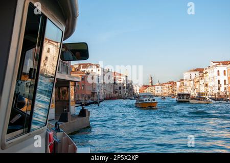 Des gondoles et des bateaux flottent sur le magnifique Grand Canal dans Venise ensoleillée, en Italie, avec des palais traditionnels en arrière-plan. Banque D'Images