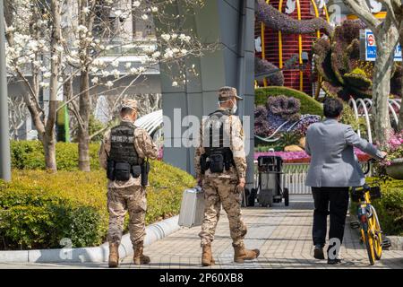 SHANGHAI, CHINE - 7 MARS 2023 - deux policiers chinois armés patrouillent la rue Lujiazui à Shanghai, Chine, le 7 mars 2023. Banque D'Images