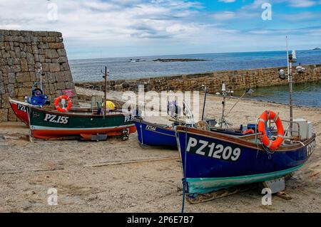 Bateaux de pêche, bleu et rouge, sur cale, port de Sennen Cove, Cornouailles, Royaume-Uni, Banque D'Images