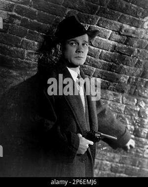 1949 : l'acteur Joseph COTTEN ( 1905 - 1994 ) dans un film pubblicavitaire pour LE TROISIÈME HOMME ( il terzo uomo ) par Carol Reed , D'un roman de Graham Greene - FILM NOIR - CINÉMA - ATTORE CINEMATOGRAFICO - collier - colletto - cravate - Cravatta - chapeau - cappello - arme - arma - pisola - pistolet - revolver - cappoto - manteau - FILM - TILLER - SUSPANCE --- Archivio GBB Archivio Banque D'Images