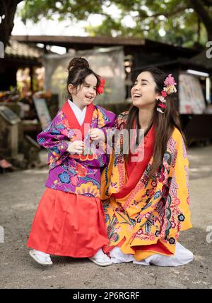 Femme d'Okinawan avec fille portant Uchinaaasugai, Ryusou, Ryuso, robe traditionnelle des îles Ryukyu, Okinawa Banque D'Images