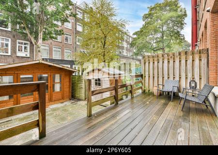 Amsterdam, pays-Bas - 10 avril 2021 : terrasse en bois avec chaises et arbres dans la cour arrière par temps ensoleillé, vue en hauteur Banque D'Images