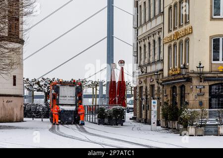 Düsseldorf par temps enneigé et boueux, collection de déchets dans la vieille ville de Burgplatz Banque D'Images