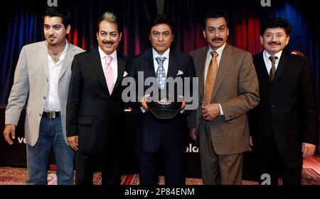 FILE - In this Aug. 12, 2009 file photo, members of Los Tigres Del Norte, from lef, Luis Hernandez, Hernan Hernandez, Jorge Hernandez, Eduardo Hernandez, and Oscar Lara pose for photographers after news conference in Los Angeles. (AP Photo/Matt Sayles, file)