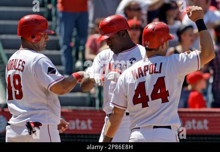 Los Angeles Angels' Gary Matthews, center, celebrates with Kendrys Morales, left, and Mike Napoli as all score on Matthews' three-run home run against the Tampa Bay Rays sixth inning of a baseball game at Anaheim, Calif., Wednesday, Aug. 12, 2009. The Angels won, 10-5. (AP Photo/Reed Saxon)