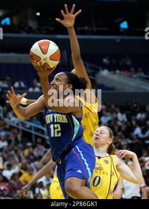 New York Liberty's Loree Moore (12) goes up for a basket on the fastbreak over Los Angeles Sparks' Kristi Harrower, right, during the first half of a WNBA basketball game in Los Angeles, Tuesday, Aug. 11, 2009. New York won the game 65-61. (AP Photo/Lori Shepler)