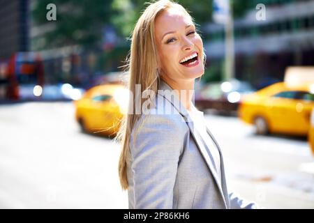 Promenez-vous dans les rues avec style. Une photo courte d'une belle femme qui marche dans la ville dans la journée. Banque D'Images