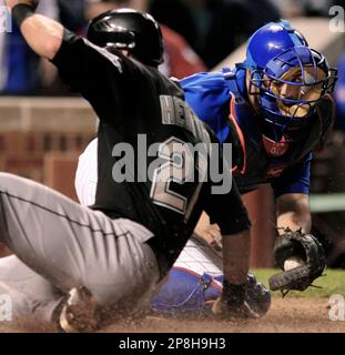 Atlanta Braves catcher Brian McCann bobbles the ball as Florida Marlins'  Jeremy Hermida slides in safe at home on a Josh Willingham single to right  that scored Joe Dillon and Hermida in