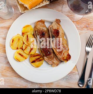 Côtelettes de sirloin de porc avec pommes de terre grillées Banque D'Images