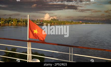 La poupe du bateau de croisière Victoria Mekong battant le drapeau vietnamien à l'aube près de Phnom Penh sur le Mékong au Cambodge. Banque D'Images