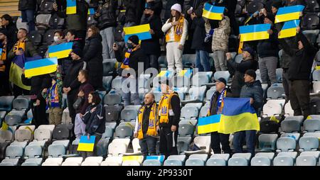 Odessa, Ukraine - novembre 2021 : les fans de football ukrainien dans des stands de stade avec des drapeaux ukrainiens et des attributs nationaux soutiennent avec enthousiasme leur Banque D'Images