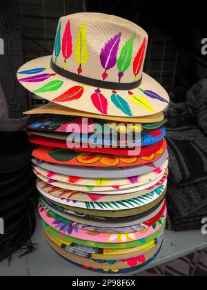 Chapeaux colorés dans une pile verticale, en vente dans une boutique touristique avec des articles du Mexique. Banque D'Images