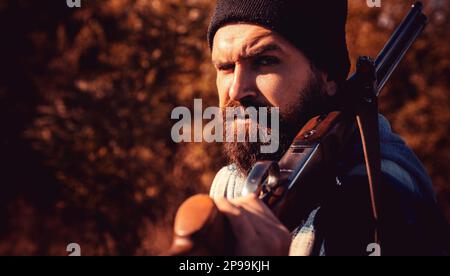 Pocher dans la forêt.Chasseur avec fusil de chasse.Recherche automatique.Saison de chasse fermée et ouverte.Chasseur barbu tenant le fusil et entrant Banque D'Images