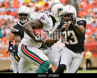 Miami Dolphins running back Ricky Williams (34) runs by Detroit Lions  corner back Amari Spievey (42) in first half action, the Lions take a 34-27  win over the Dolphins at Sun Life