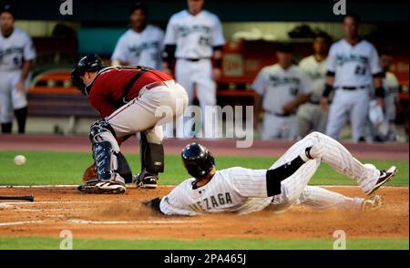 Atlanta Braves catcher Brian McCann bobbles the ball as Florida Marlins'  Jeremy Hermida slides in safe at home on a Josh Willingham single to right  that scored Joe Dillon and Hermida in