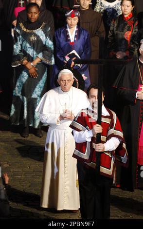 Pope Benedict XVI Follows A Lay Person Carrying A Wooden Cross During ...