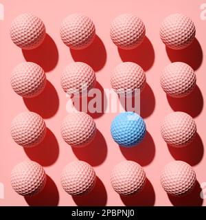 Balle de golf bleue se tenant à l'écart de la foule parmi les balles de golf roses. Balles de golf de suite. Résumé encore vie art. 3D rendu. Banque D'Images