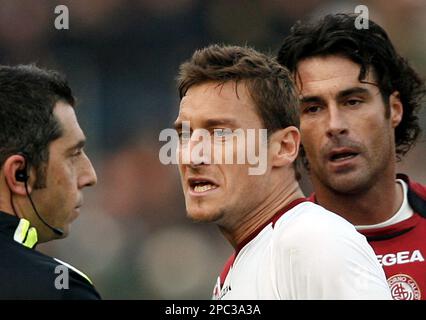 AS Roma's captain Francesco Totti, center with white jersey, sorrounded by  teammetes, holds the trophy with Italian President Giorgio Napolitano,  second from right, and Italian soccer league president Antonio Matarrese,  right, after