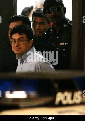 Abdul Razak Baginda, center, is escorted by police officers upon his ...