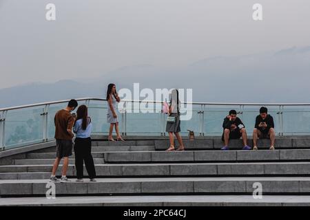 Chiang Mai, Thaïlande. 13th mars 2023. Touristes vus sur le toit du bâtiment dans la ville de Chiang Mai où la pollution de l'air peut être vue partout dans le ciel. Chiang Mai est devenue la ville polluée la plus élevée au monde avec une concentration de PM2,5 de plus de 100,3 µg/m³ que plus de 20 fois la valeur annuelle de la recommandation DE l'OMS sur la qualité de l'air. La ville était couverte par la brume de pollution de l'air qui pourrait avoir des effets sur la santé. Crédit : SOPA Images Limited/Alamy Live News Banque D'Images