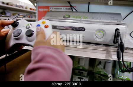 Christine Canasa plays a game using the new Xbox 360 game console