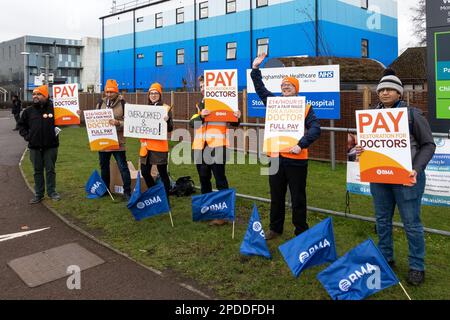 En grève pour un salaire équitable, les jeunes médecins, membres de la British Medical Association (BMA), en dehors de leur hôpital NHS Stoke Mandeville de renommée mondiale à Aylesbury, Royaume-Uni. Les voitures qui passent ont aiguisé leurs cornes pour soutenir les jeunes médecins ici photographiés le matin de leur premier jour de leur grève de 72 heures. Crédit : Stephen Bell/Alay Banque D'Images