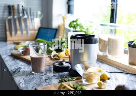 Gros plan du smoothie dans un verre à boire avec fruits et mixeur sur le comptoir de la cuisine, espace de copie Banque D'Images