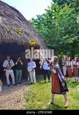 Traditions spécifiques de Sanziene - célébration roumaine avec des garçons et des filles de la campagne vêtus de costumes traditionnels dansant et chantant Banque D'Images