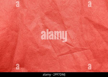 Gros plan sur la texture du tissu en polyester corail comme arrière-plan Banque D'Images