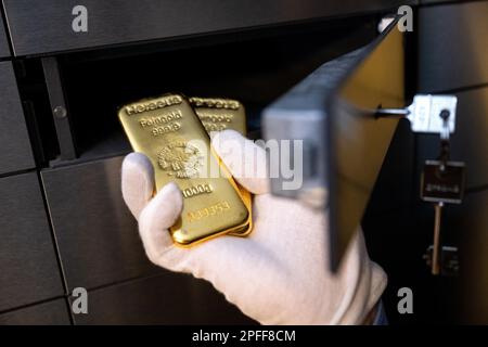 Munich, Allemagne. 16th mars 2023. Un homme place deux barres d'or dans un casier dans une voûte au marchand de métaux précieux Pro Aurum. Credit: Sven Hoppe/dpa/Alay Live News Banque D'Images