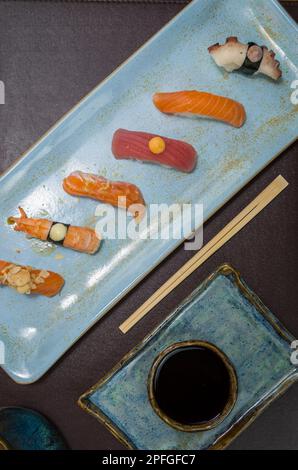 Sushi japonais de qualité différente ( niguiri) sur une assiette élégante. Banque D'Images