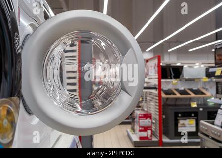Ouvrez la porte d'un lave-linge dans un magasin d'appareils ménagers. Banque D'Images