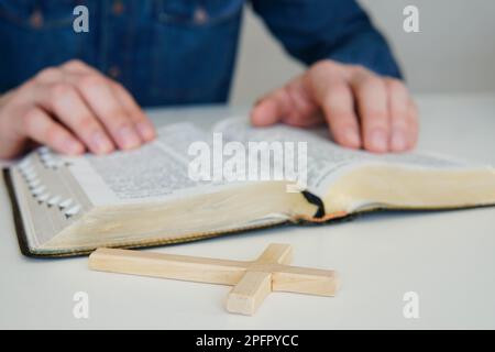 L'homme catholique chrétien se concentre sur la lecture de la Sainte Bible à la maison. Lectures du dimanche. Banque D'Images