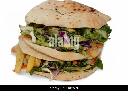 Pain syrien plat Shami rempli de frites et de salade verte, sandwich traditionnel égyptien avec des doigts de pommes de terre frits entouré de frais et croquant Banque D'Images