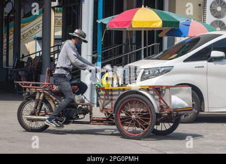 BANGKOK, THAÏLANDE, JANVIER 28 2023, Un homme conduit un tricycle avec une plate-forme de cargaison Banque D'Images