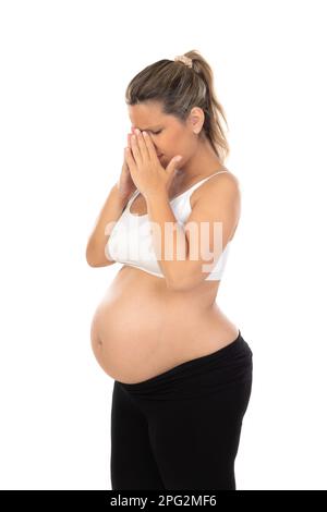 Gêne pendant la grossesse. Femme enceinte isolée sur fond blanc Banque D'Images