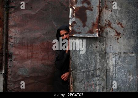 Gaza, Palestine. 20th mars 2023. Les Palestiniens traversent une rue inondée d'eau de pluie à Lahiya, au nord de la ville de Gaza. Banque D'Images