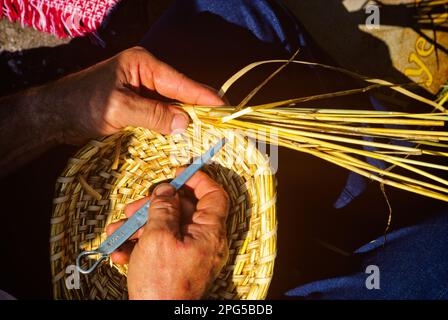 1980S PANIER TISSAGE DES MAINS EN UTILISANT UN METALTOOL EN TISSAGE DES ROSEAUX ET DES HERBES - 080420 BAR007 HARS CONCEPTUEL ARTS GROS-UP HERBES CRÉATIVITÉ ROSEAUX DE PRÉCISION TISSAGE TANDIS QUE LES MAINS SEULEMENT DÉMODÉES Banque D'Images