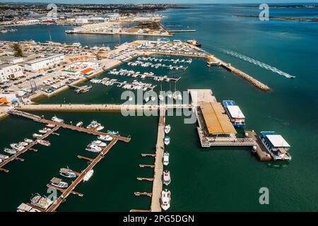 Vue aérienne de drone des touristes sur un quai partant d'un ferry sur la Ria Formosa, région de l'Algarve, Portugal Banque D'Images