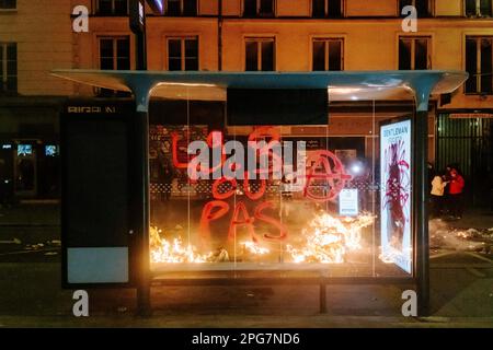 Jan Schmidt-Whitley/le Pictorium - rallye spontané et manifestation sauvage à Paris - 20/3/2023 - France / Paris / Paris - Un graffiti contre le 49,3 sur un abri de bus avec un feu de déchets en arrière-plan. Une fois la réforme des retraites adoptée après le rejet des deux motions de censure, des rassemblements spontanés ont été signalés dans toute la France. A Paris, plusieurs milliers de personnes se sont rendu à Paris pour frapper et mettre le feu dans les poubelles tout en jouant à la cachette et à la recherche avec la police. De nombreux affrontements ont eu lieu au cours de ces marches et la police a violemment inculpé et battu les manifestants sur sev Banque D'Images