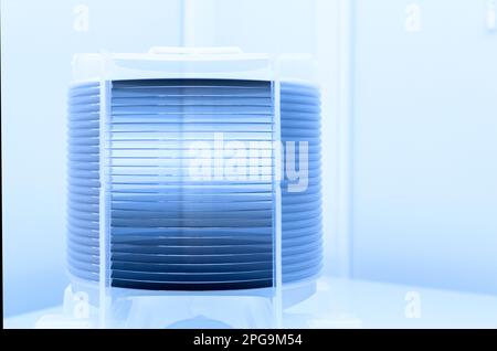 Lot de plaquettes de silicium conditionnées dans une boîte de stockage en plastique dans la salle blanche d'une fonderie de semi-conducteurs prête pour la production de micropuces. Banque D'Images