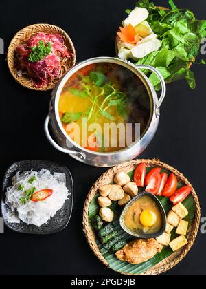 Hot pot coréen épicé avec viande de boeuf et nouilles sur fond noir Banque D'Images