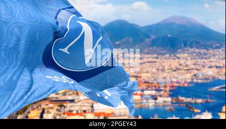 Naples, IT, Mars 2023: Drapeau de l'équipe de football de Naples agitant avec la baie de Naples et le Vésuve flou en arrière-plan. Editoria illustratif Banque D'Images