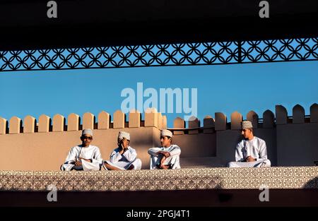 Garçons vês de vêtements traditionnels sur le toit du marché de la chèvre, Nizwa, Oman Banque D'Images