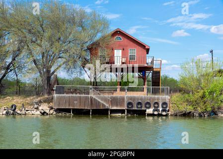 Une petite maison sur pilotis sur la rive de la rivière Rio Grande à Mission, Texas. Banque D'Images