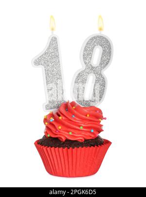 18th anniversaire. Délicieux cupcake avec des bougies en forme de nombre pour venir de la fête d'âge sur fond blanc Banque D'Images