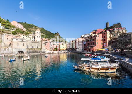 Italie, Ligurie, Vernazza, bord de ville côtière le long de Cinque Terre avec des bateaux amarrés en premier plan Banque D'Images