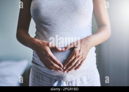 J'ai hâte de vous donner le monde. une femme enceinte touchant son ventre. Banque D'Images