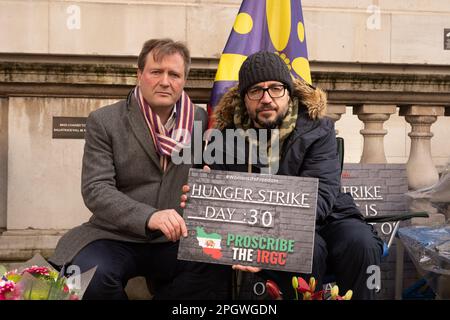 Londres, Royaume-Uni. 24 MARS 2023. Le journaliste et activiste des droits humains Vahid Beheshti, qui est le 30 jour de sa grève de la faim, est visité par Richard Ratcliffe. Vahid Beheshti mène actuellement une grève de la faim devant les bureaux des Affaires étrangères et du Commonwealth pour mettre en lumière les violations des droits de l'homme commises par l'IRGC (corps des Gardiens de la révolution islamique). Et appelant le gouvernement britannique à proscrire l'IRCG en tant qu'organisation terroriste. Aubrey Fagon/Alamy Live News Banque D'Images